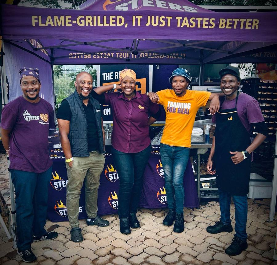 The team under the flame-grilled gazebo